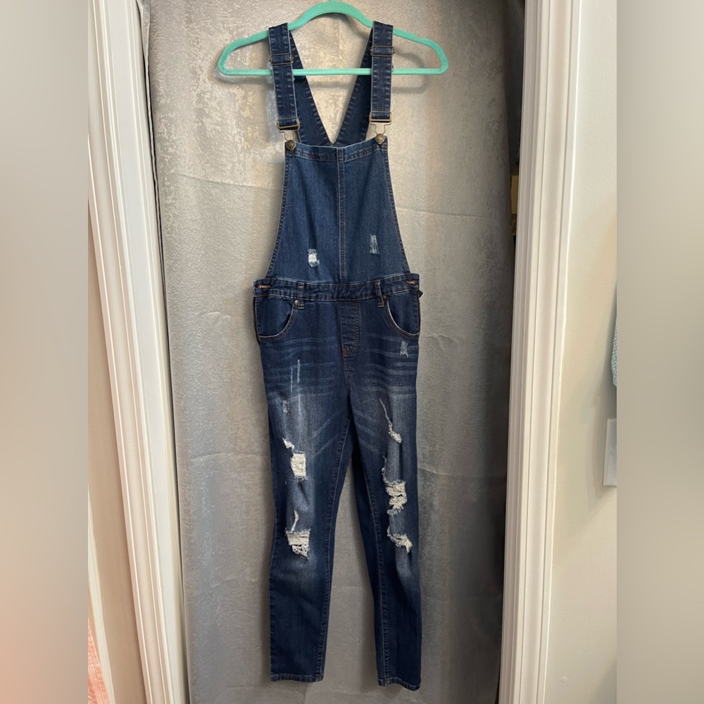 Women’s distressed, dark jean overalls